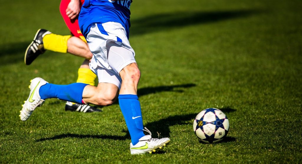 Footballer kicking ball