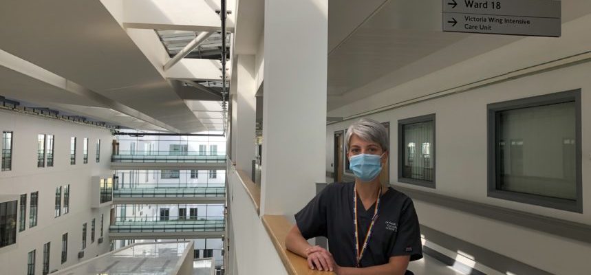 A nurse wearing a mask stood in a hospital hallway