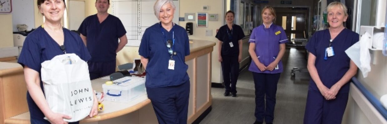 Staff in a ward smiling.