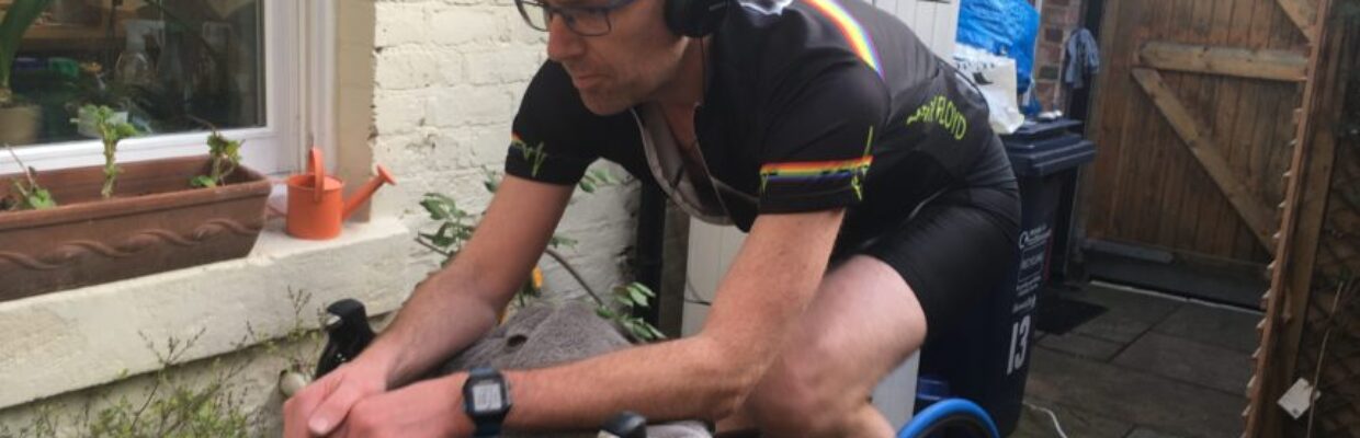 Keith Farquharson on a bike with headphones.