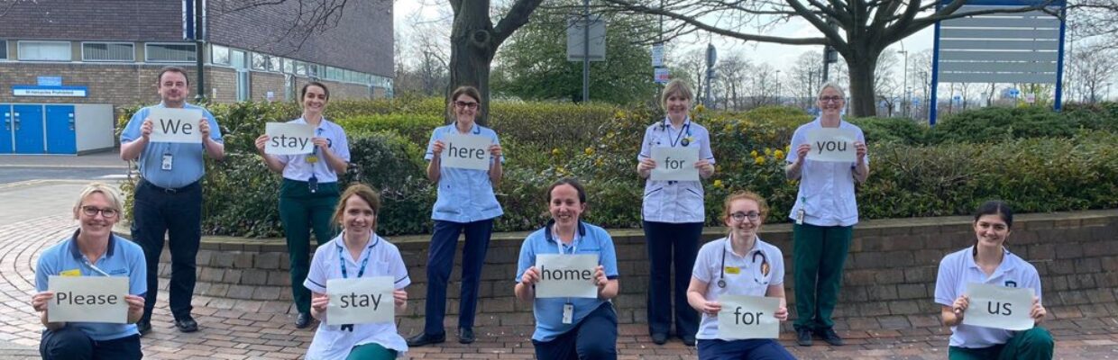 A group of nurses holding signs