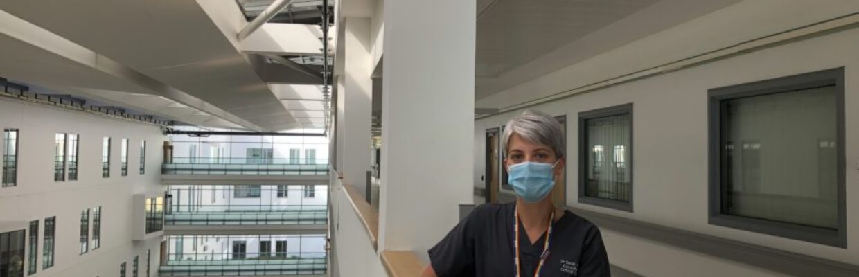 A nurse wearing a mask stood in a hospital hallway