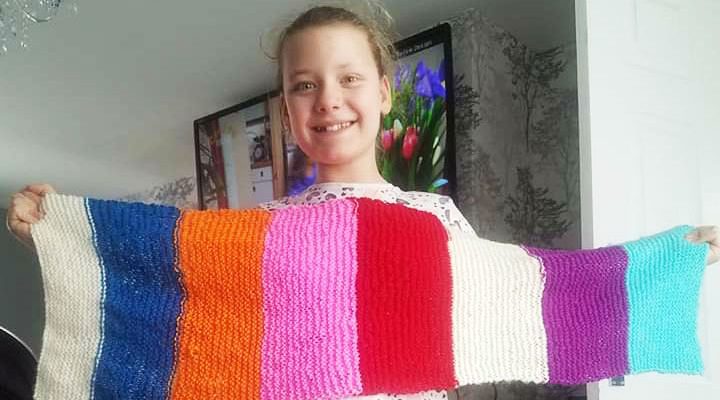 Gabrielle Rutherford holding her homemade scarf.