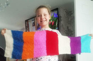 Gabrielle Rutherford holding her homemade scarf.