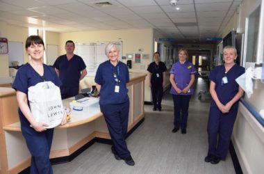 Staff in a ward smiling.