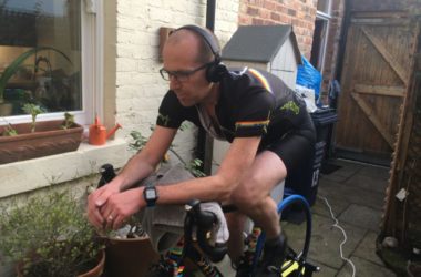 Keith Farquharson on a bike with headphones.