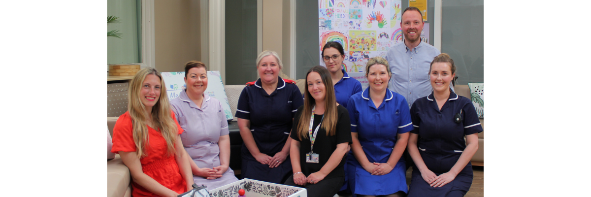 NHS staff and other people celebrating the launch of the Baby Box