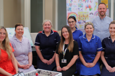 NHS staff and other people celebrating the launch of the Baby Box